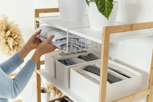a woman is organizing her small apartment